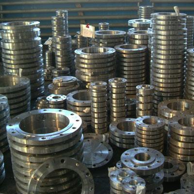 stack of industrial stainless steel pipe flanges in different sizes used in high-pressure piping systems